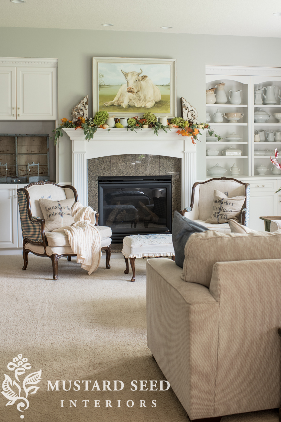 Decorating for fall on our mantel using fall leaf garland with berries and mini pumpkins. | missmustardseed.com