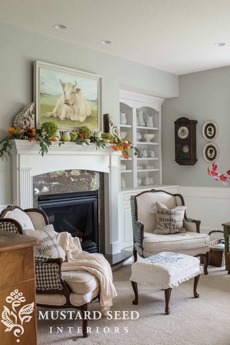 Decorating for fall on our mantel using fall leaf garland with berries and mini pumpkins. | missmustardseed.com