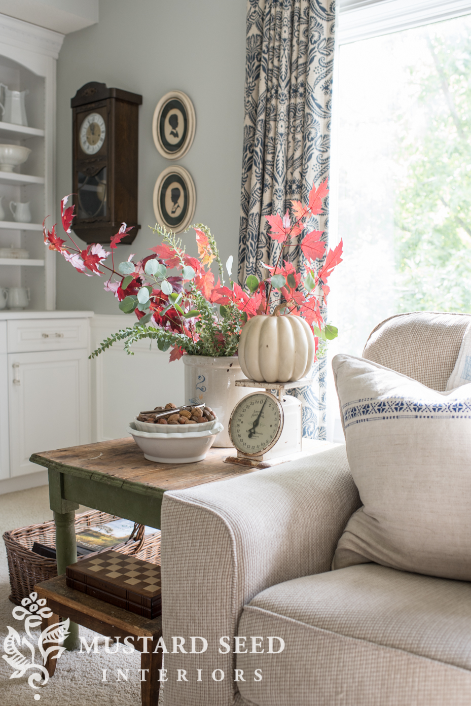 Decorating for fall in living room, faux pumpkin, fall branches. | missmustardseed.com