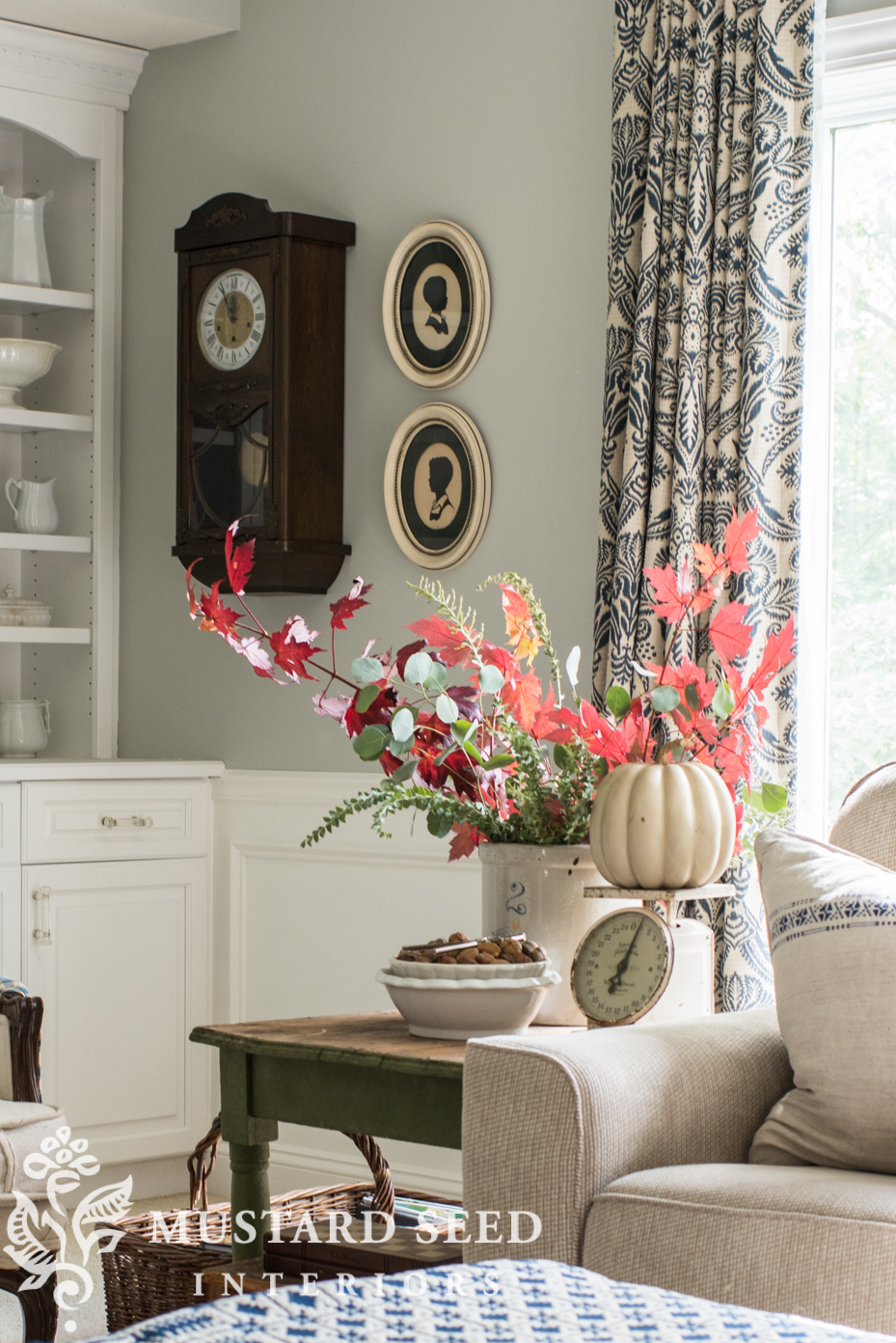 Decorating for fall in living room, faux pumpkin, fall branches. | missmustardseed.com