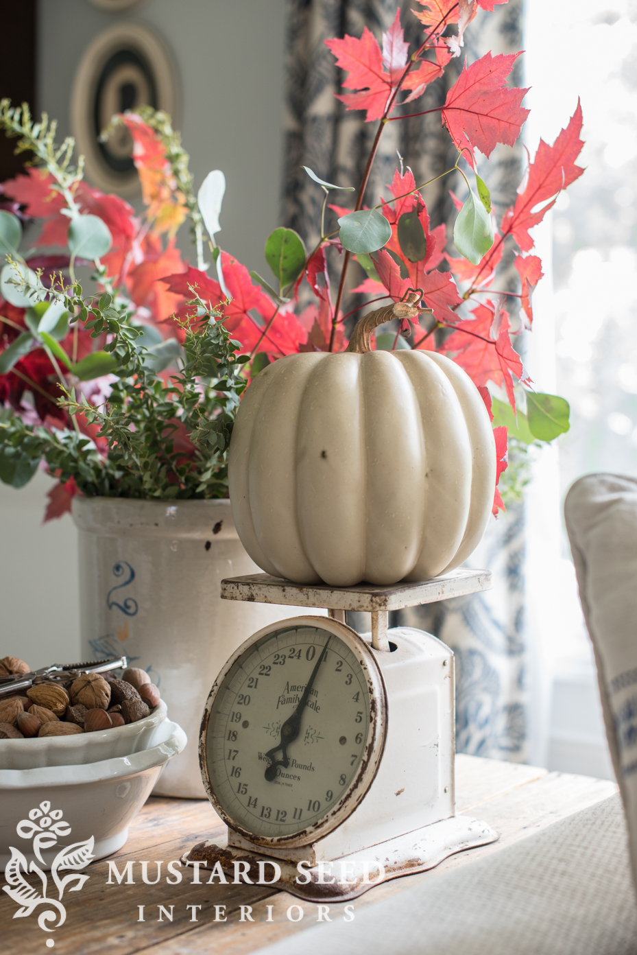 Decorating for fall in living room, faux pumpkin on antique scale, fall branches. | missmustardseed.com