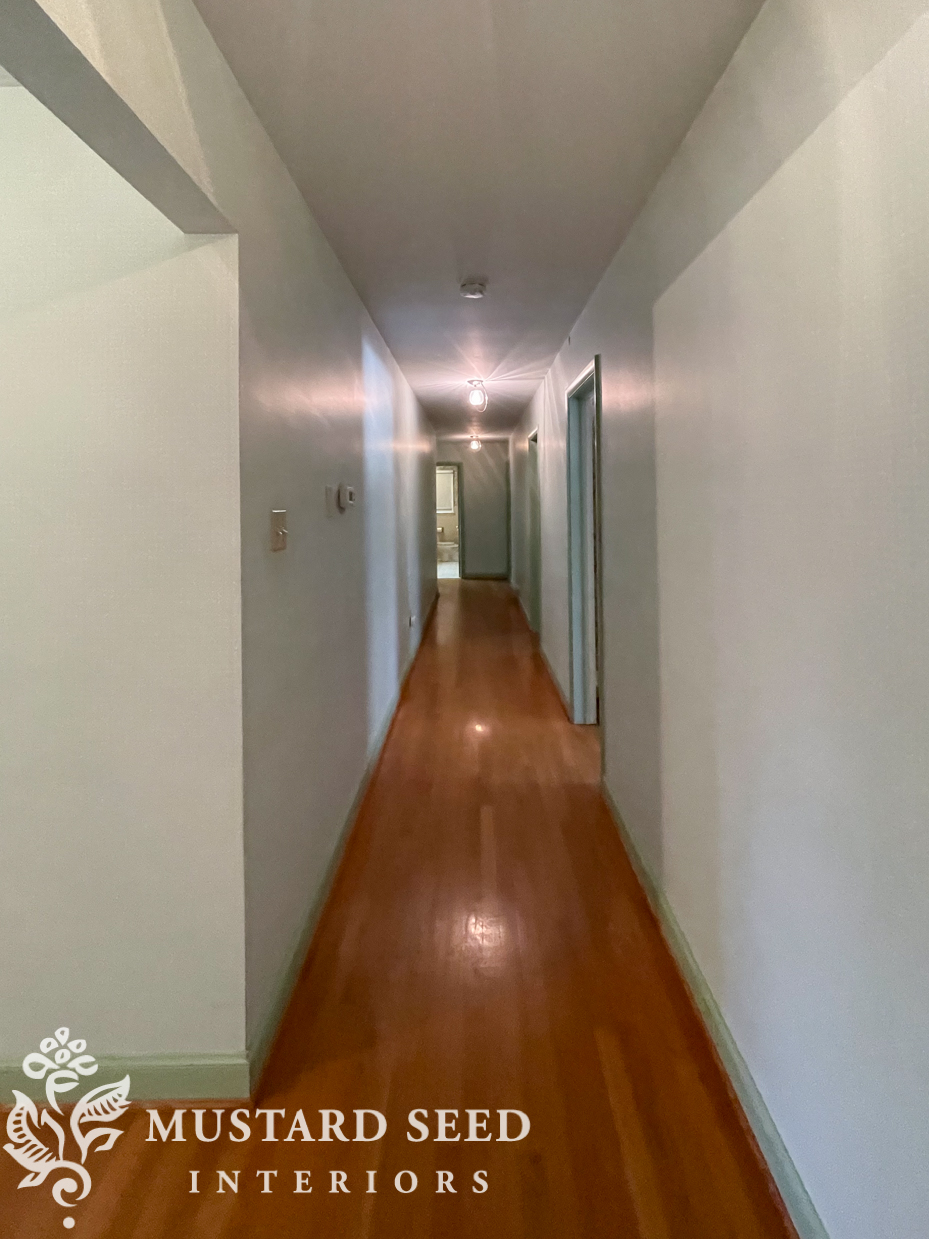 long hallway with green wallpaper | miss mustard seed