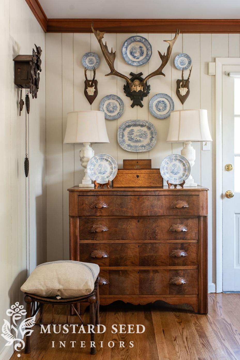 antique plates and antlers wall arrangement | miss mustard seed