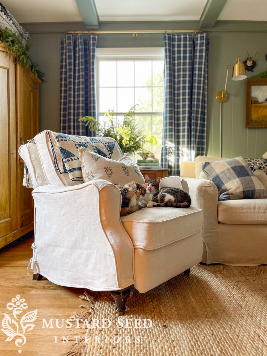 cats snuggling on a slipcovered chair | miss mustard seed
