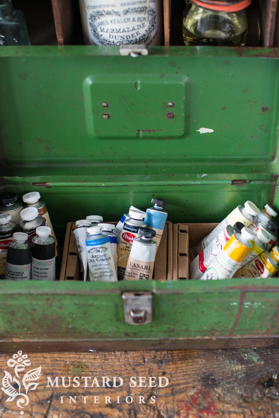 green antique tool box filled with oil paints | missmustardseed.com