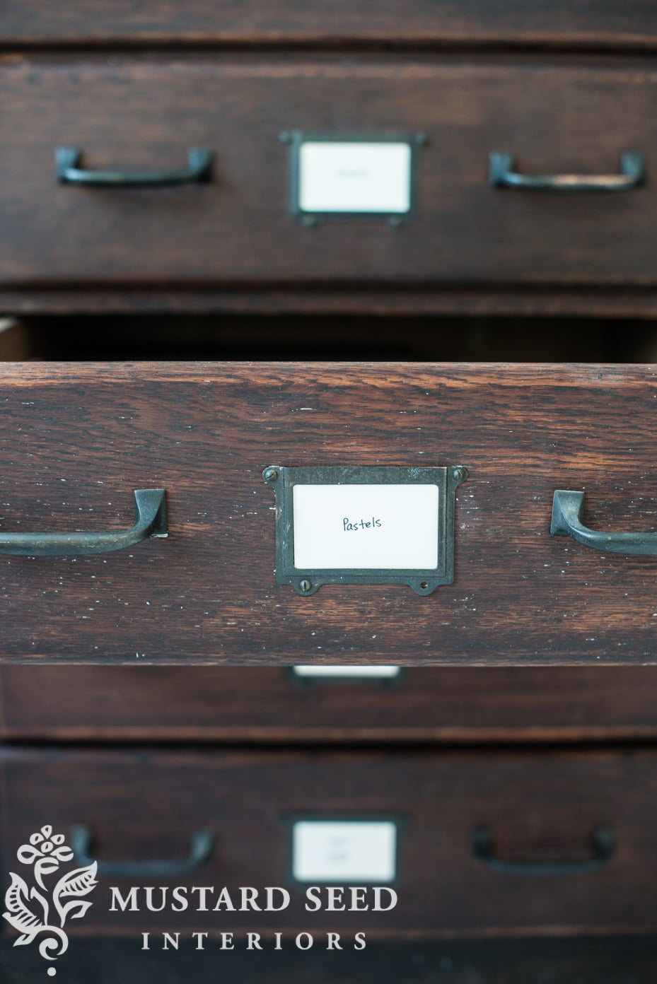 drawer labels on an antique hardware store cabinet | art studio organization | missmustardseed.com