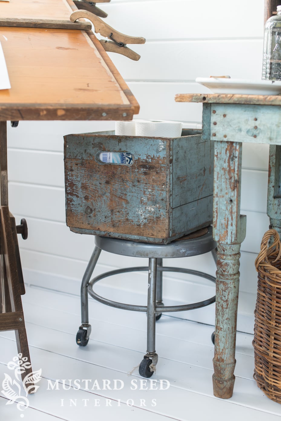 wheeled stool holds a crate with bulky supplies | missmustardseed.com